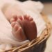 Free Baby's Feet on Brown Wicker Basket Stock Photo